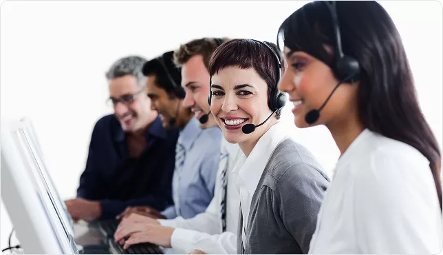 Smiling call centre team wearing headsets at computers, delivering professional customer service in Sydney